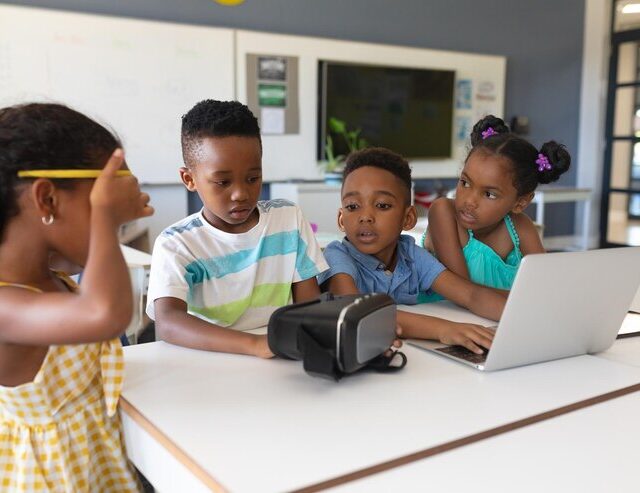 african-american-elementary-school-students-using-vr-glasses-laptop-desk-classroom_13339-304147